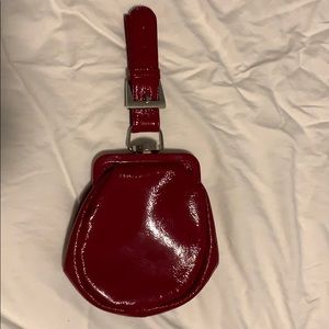 A red fake leather clutch with a checkered inside.